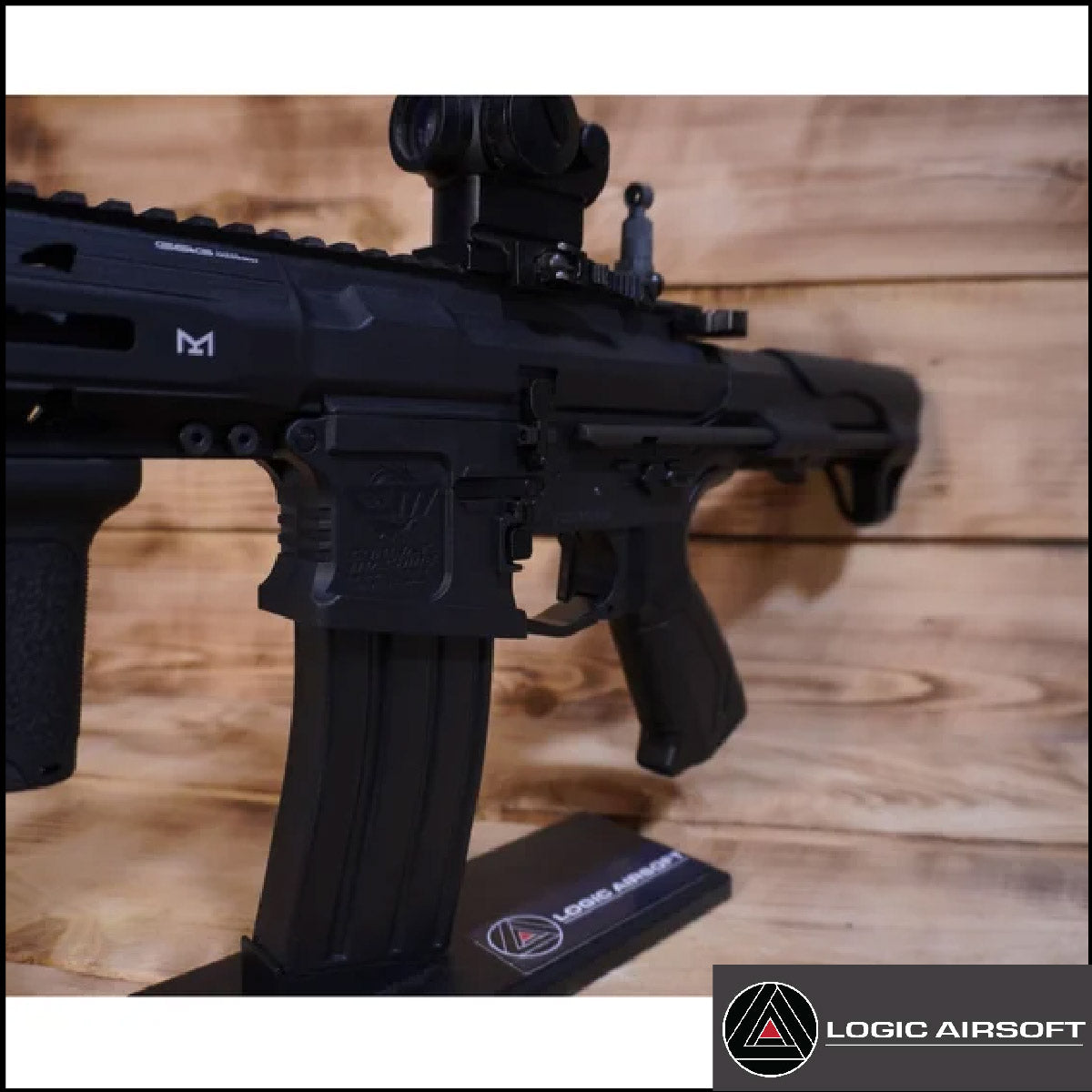 Black airsoft AEG rifle receiver with scope and pistol grip, close-up